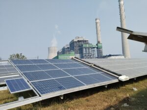 Waterless solar panel cleaning robot cleaning in between a Thermal Power power plant and a cement factory